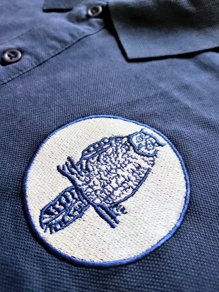 Leeds United Owl badge on a navy polo shirt